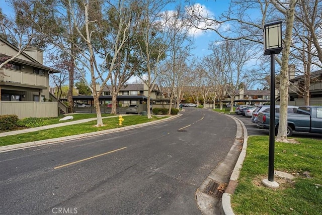 view of road with sidewalks, curbs, and a residential view