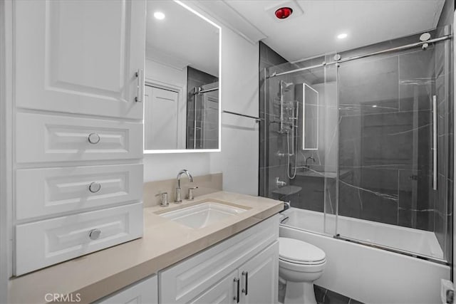 bathroom featuring enclosed tub / shower combo, vanity, and toilet