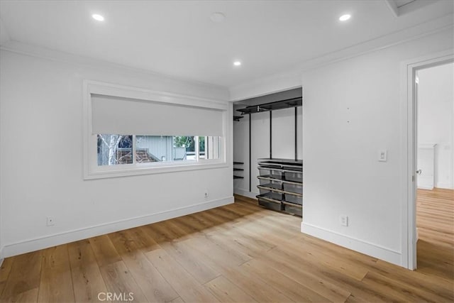 unfurnished bedroom with crown molding and wood finished floors