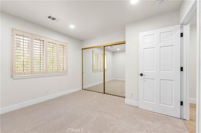 unfurnished bedroom featuring baseboards, visible vents, carpet floors, a closet, and recessed lighting