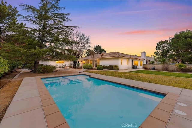 pool featuring a patio and a yard