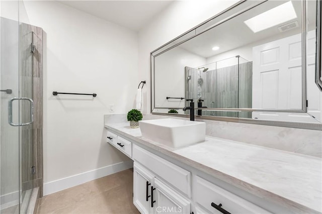 bathroom with visible vents, a shower stall, vanity, and baseboards