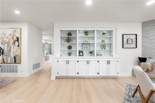 interior space featuring light wood-type flooring, baseboards, visible vents, and recessed lighting