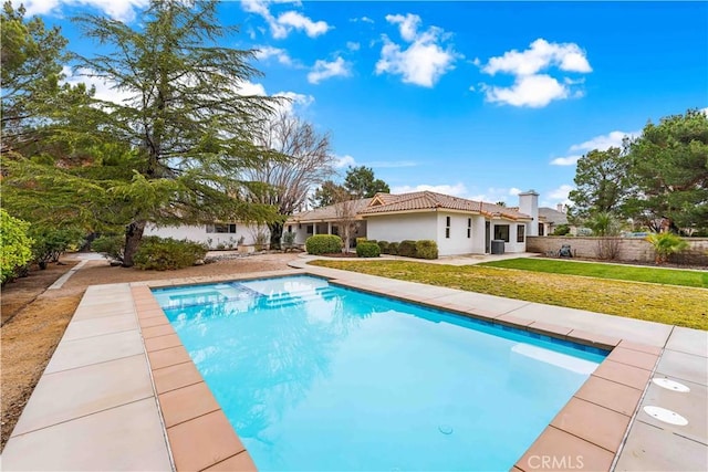 view of swimming pool with a patio area, a fenced in pool, and a lawn