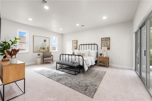 carpeted bedroom featuring recessed lighting, visible vents, and baseboards