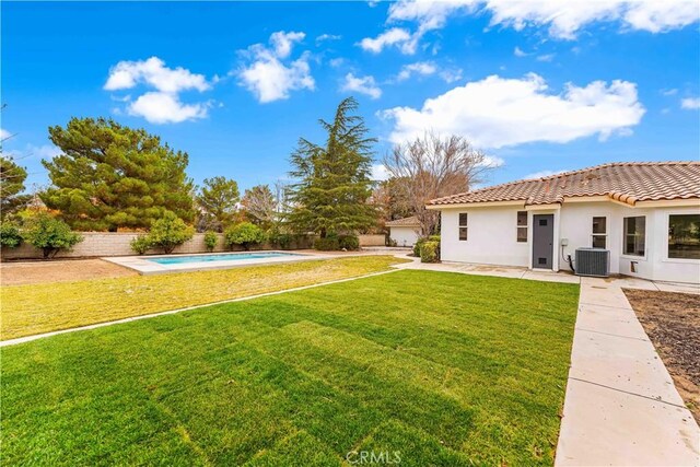 view of yard with a fenced in pool, fence private yard, central AC, and a patio