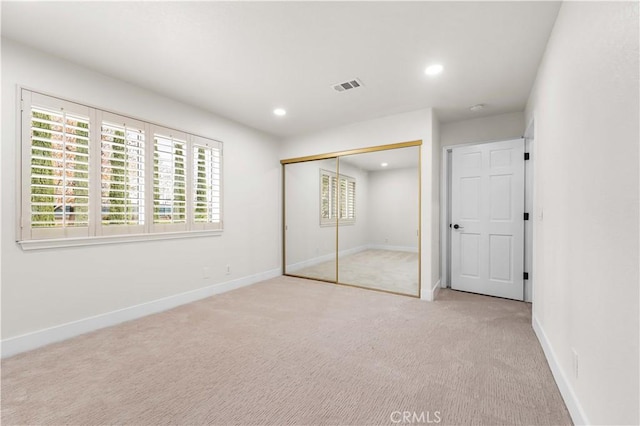 unfurnished bedroom with a closet, recessed lighting, visible vents, and baseboards