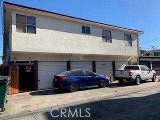 view of front of house with a garage and stucco siding