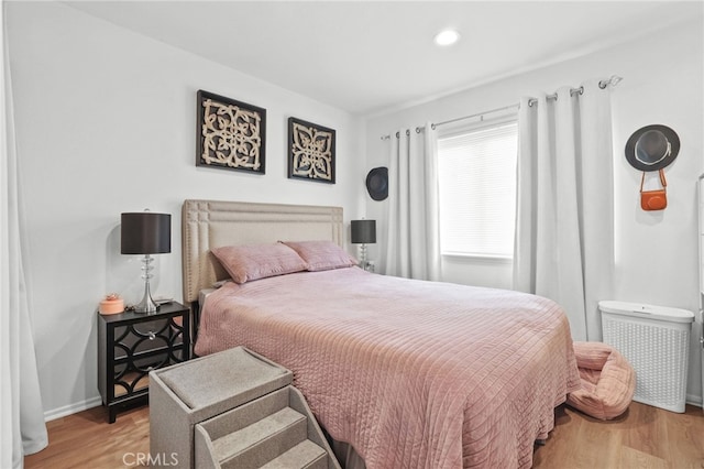 bedroom featuring recessed lighting, wood finished floors, and baseboards