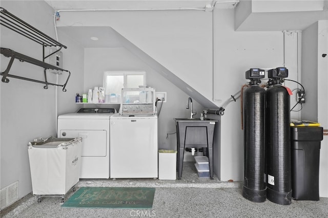 clothes washing area with visible vents, separate washer and dryer, and laundry area