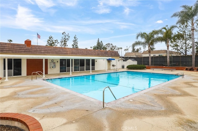 pool featuring a patio area and fence