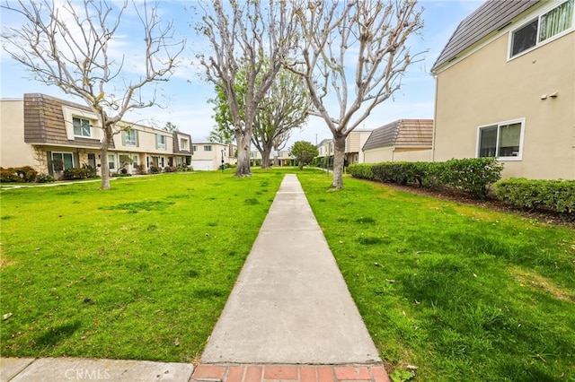 view of community with a residential view and a lawn