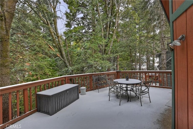 wooden terrace featuring outdoor dining area