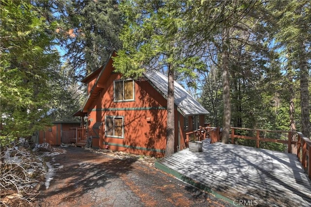 view of property exterior with a wooden deck