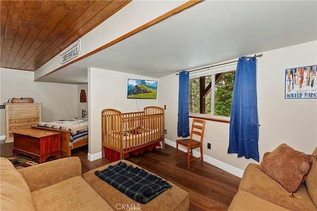 bedroom with wood ceiling, baseboards, and wood finished floors