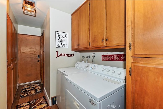 washroom with separate washer and dryer and cabinet space