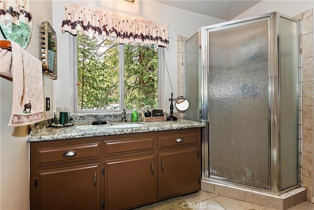 bathroom featuring a stall shower, vanity, and tile patterned floors