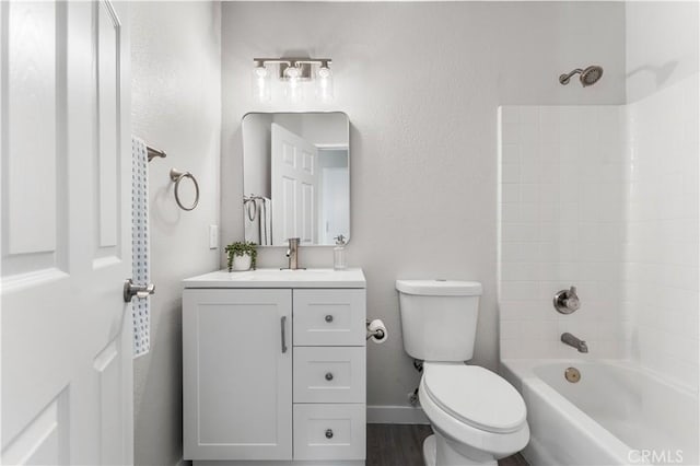 full bath with toilet, bathing tub / shower combination, baseboards, and vanity