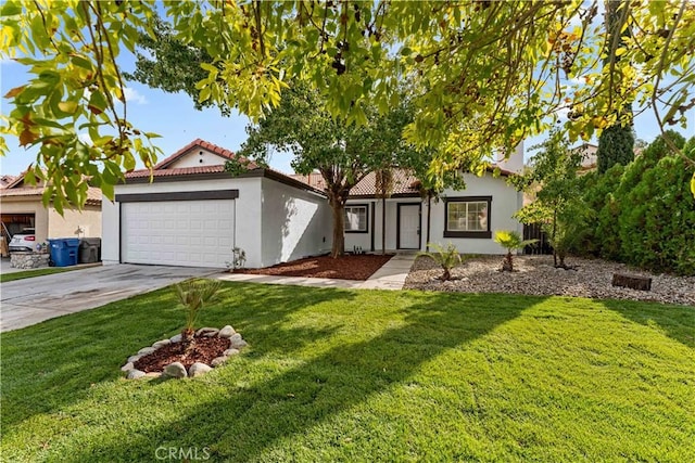 view of front of home featuring a garage, driveway, a front lawn, and stucco siding