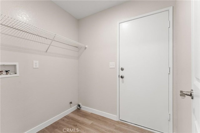 washroom featuring hookup for a washing machine, light wood-type flooring, laundry area, and baseboards