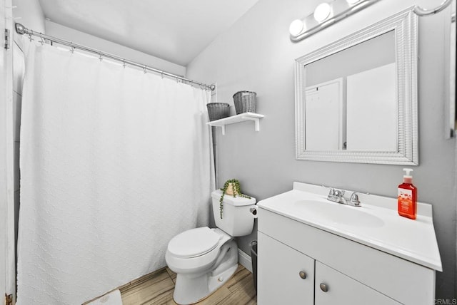 bathroom with toilet, wood finished floors, vanity, baseboards, and a shower with curtain