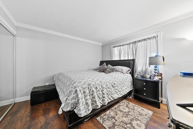 bedroom featuring a closet, crown molding, and wood finished floors