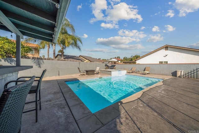 view of swimming pool with a patio area, a fenced backyard, and a pool with connected hot tub