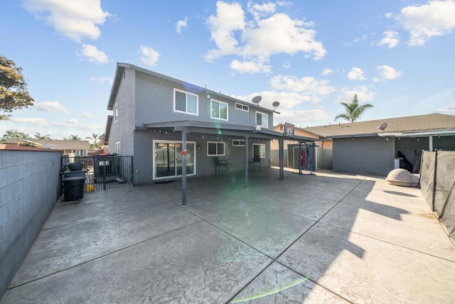 view of front of property featuring a patio area, a fenced backyard, and stucco siding