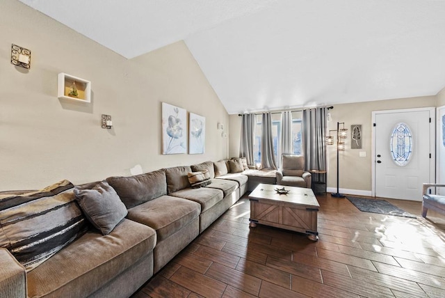 living room with lofted ceiling, wood finish floors, and baseboards