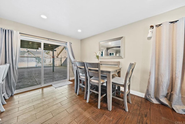 dining space featuring recessed lighting, wood finished floors, and baseboards