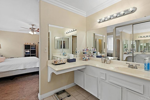 ensuite bathroom with connected bathroom, ceiling fan, ornamental molding, tile patterned flooring, and vanity