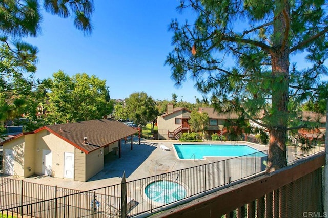 pool featuring a patio area and fence