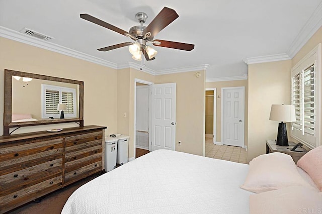 bedroom with a ceiling fan, tile patterned floors, visible vents, and crown molding