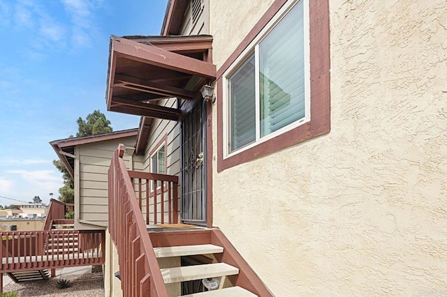 exterior space with a wooden deck and stucco siding