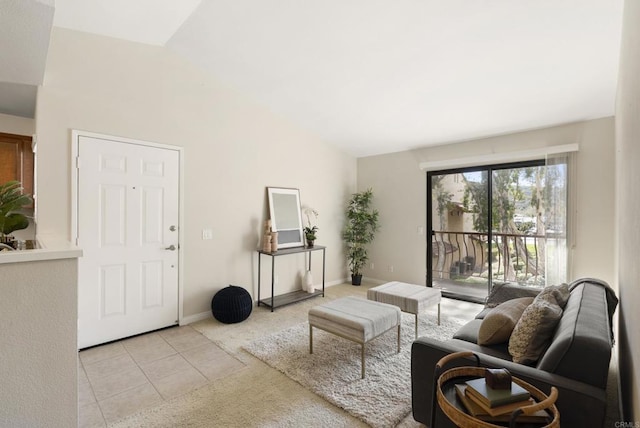 tiled living area featuring lofted ceiling and baseboards