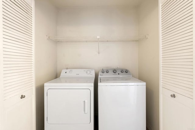 clothes washing area featuring laundry area and washer and dryer