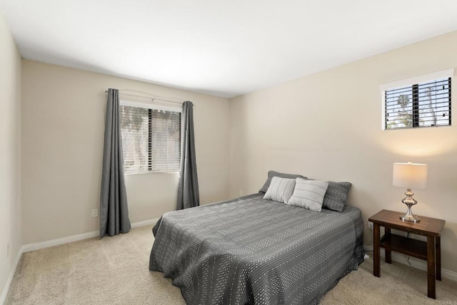 bedroom featuring carpet floors and baseboards