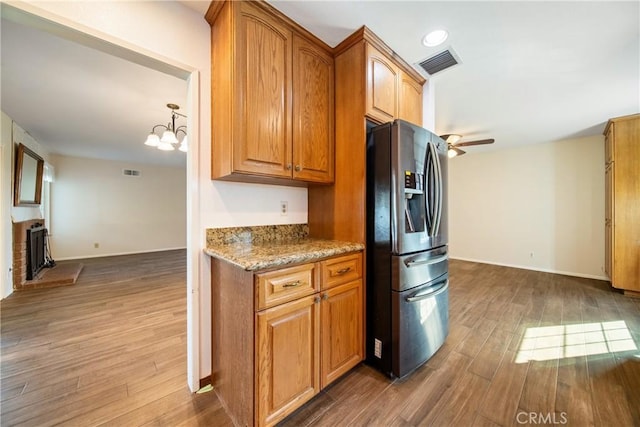 kitchen with visible vents, wood finished floors, and stainless steel fridge with ice dispenser