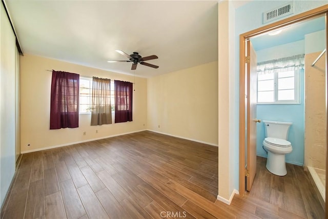 interior space featuring a wealth of natural light, visible vents, and wood finished floors