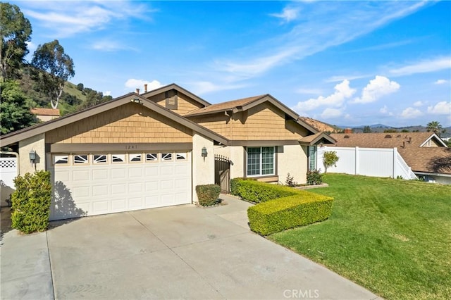 ranch-style house featuring an attached garage, fence, driveway, stucco siding, and a front lawn