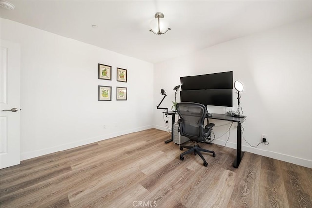 office space with baseboards and wood finished floors