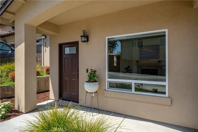 entrance to property featuring stucco siding