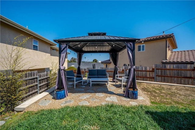 view of patio featuring an outdoor hangout area, a gazebo, and fence