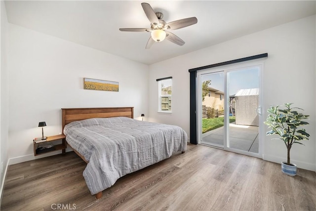 bedroom featuring ceiling fan, access to outside, wood finished floors, and baseboards