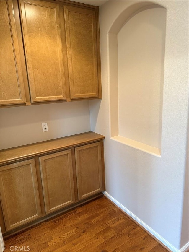 8853 Hollyhock Ct, Corona, CA 92883 - detailed view of wood finished floors, baseboards, and arched walkways