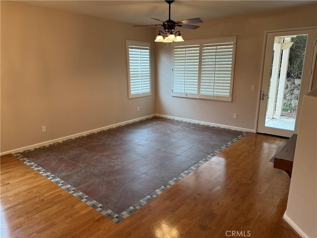 8853 Hollyhock Ct, Corona, CA 92883 - spare room featuring plenty of natural light, a ceiling fan, baseboards, and dark wood-style flooring