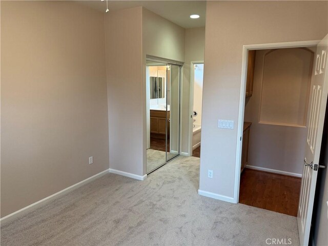 8853 Hollyhock Ct, Corona, CA 92883 - unfurnished bedroom featuring carpet floors, baseboards, and ensuite bathroom