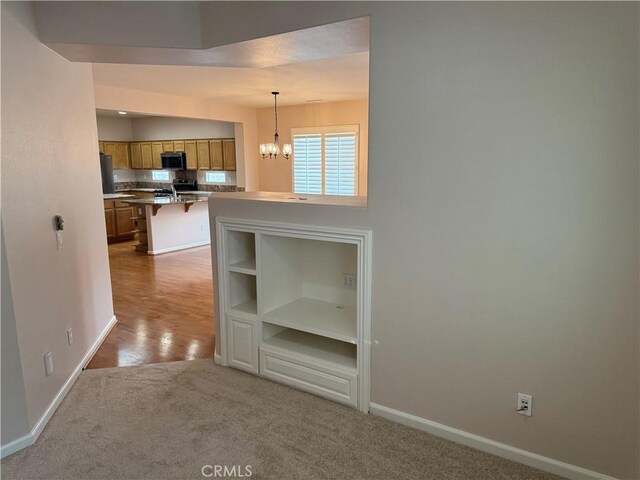 8853 Hollyhock Ct, Corona, CA 92883 - interior space featuring baseboards, carpet flooring, and a chandelier