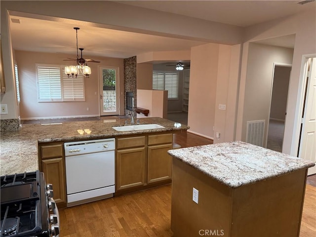 8853 Hollyhock Ct, Corona, CA 92883 - kitchen with dishwasher, a sink, a ceiling fan, stainless steel gas stove, and a peninsula