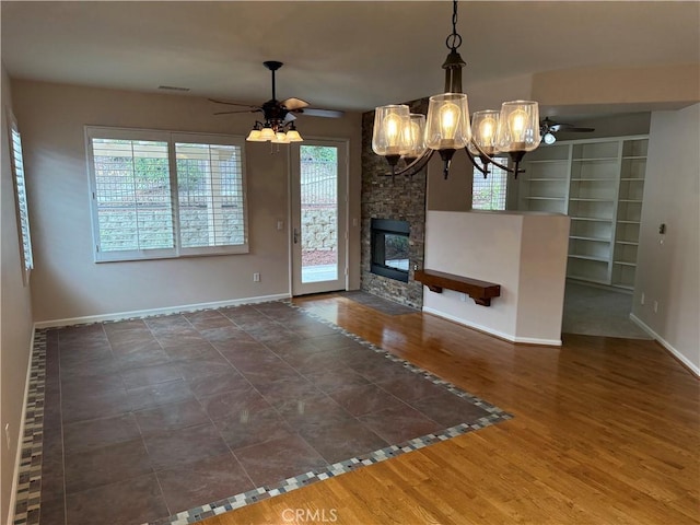8853 Hollyhock Ct, Corona, CA 92883 - unfurnished living room with a ceiling fan, baseboards, and a chandelier